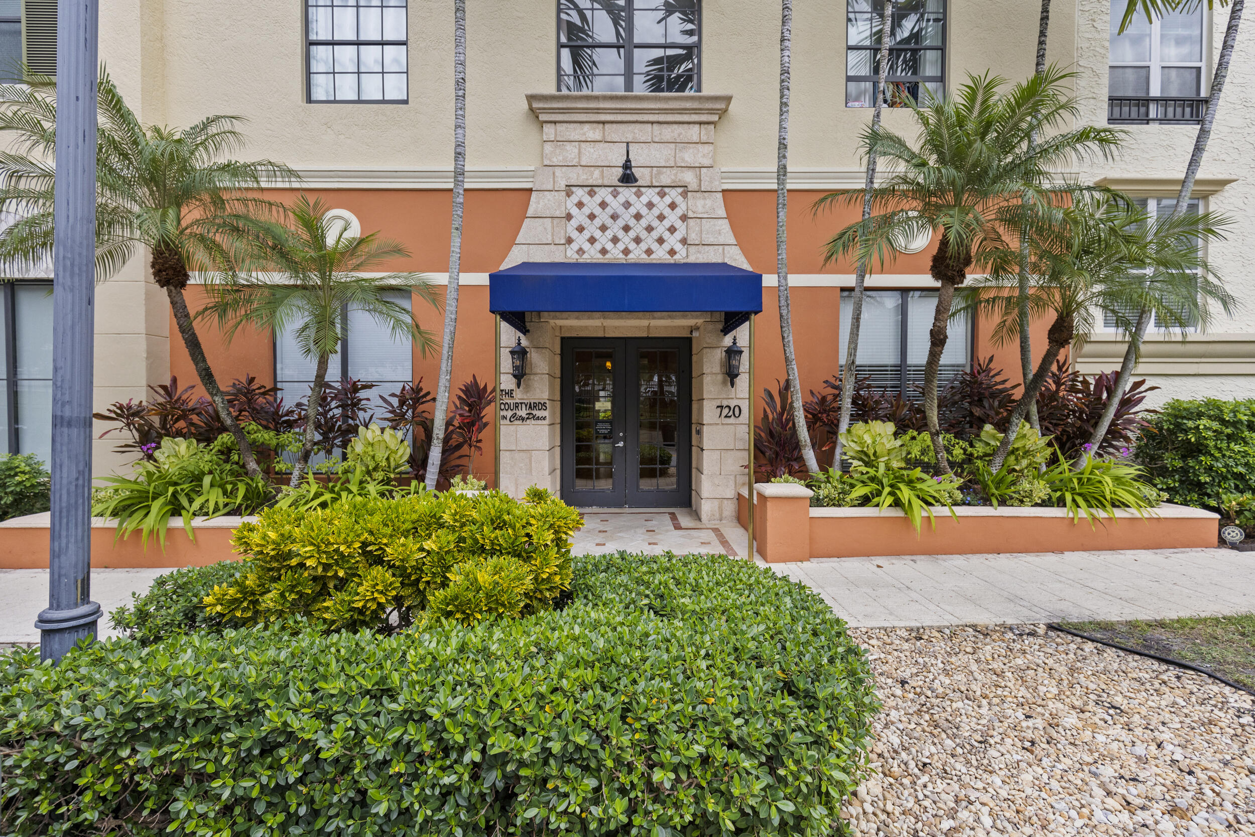 630 South Sapodilla Avenue, Unit 202 West Palm Beach, FL 33401 - Photo 28 of 31 front view of a house with a yard