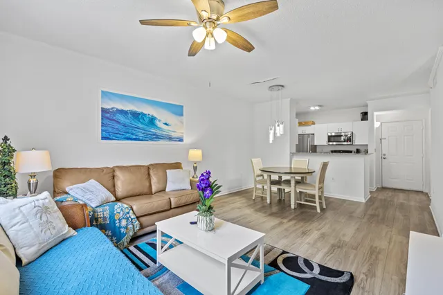 a living room with furniture and kitchen view