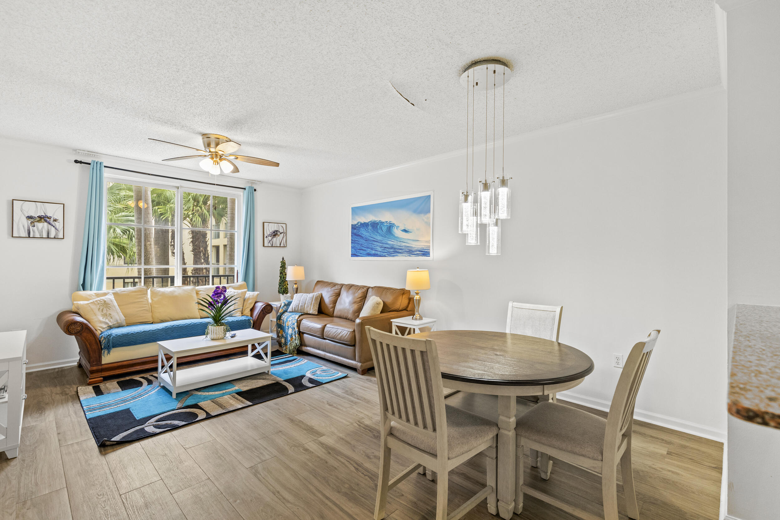 630 South Sapodilla Avenue, Unit 202 West Palm Beach, FL 33401 - Photo 6 of 31 a living room with furniture a window and a dining table
