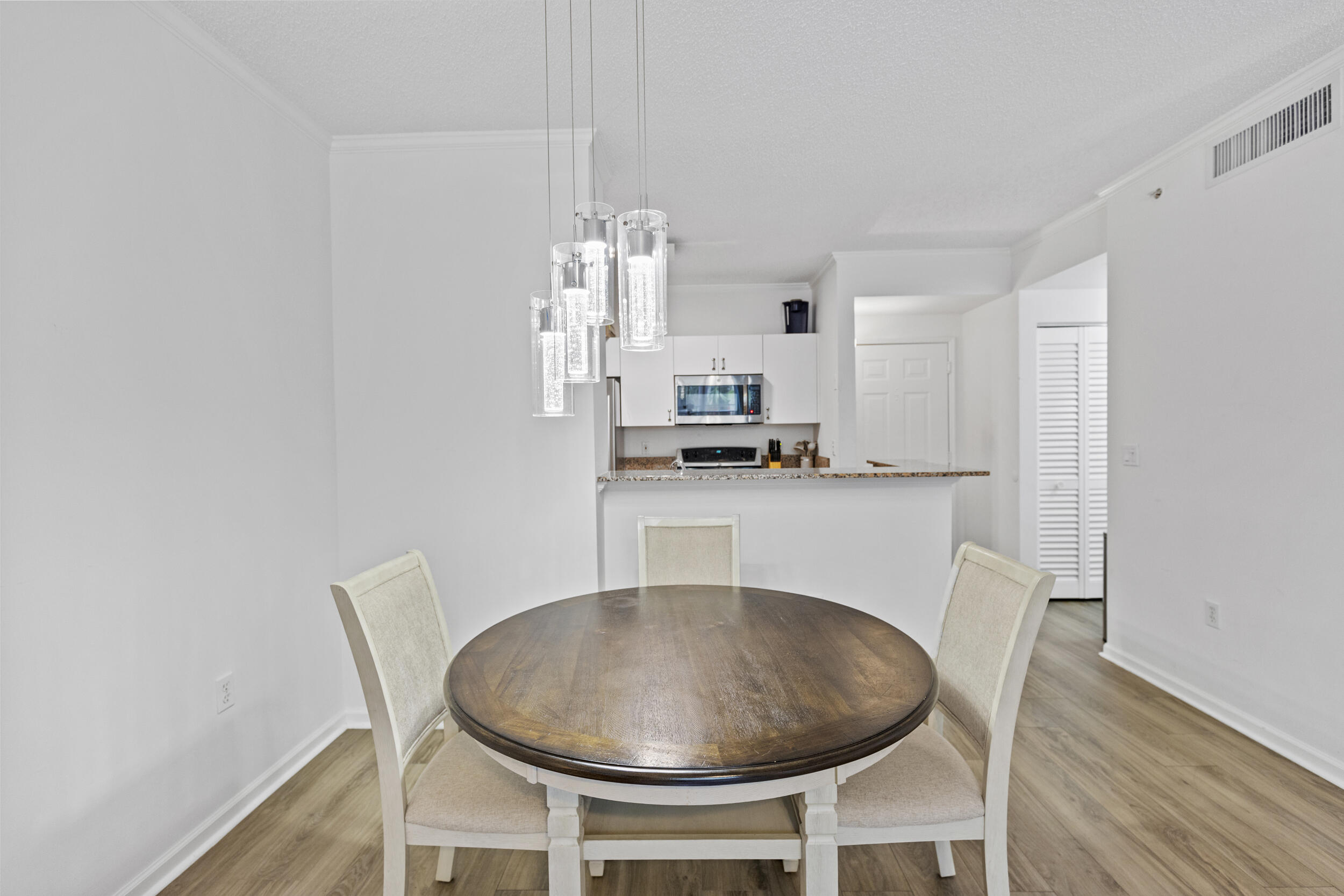630 South Sapodilla Avenue, Unit 202 West Palm Beach, FL 33401 - Photo 7 of 31 a dining room with furniture and chandelier