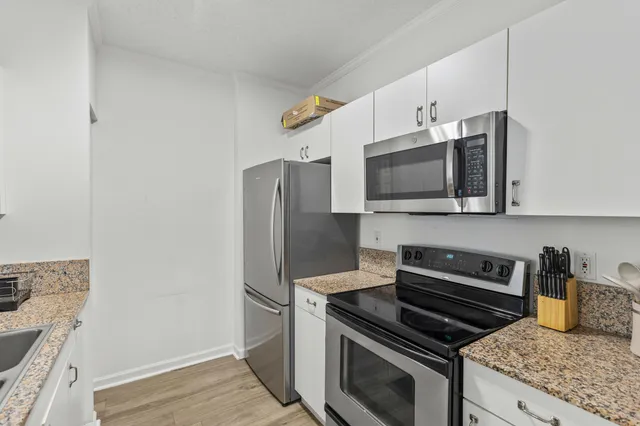 a kitchen with stainless steel appliances a stove a microwave and a refrigerator