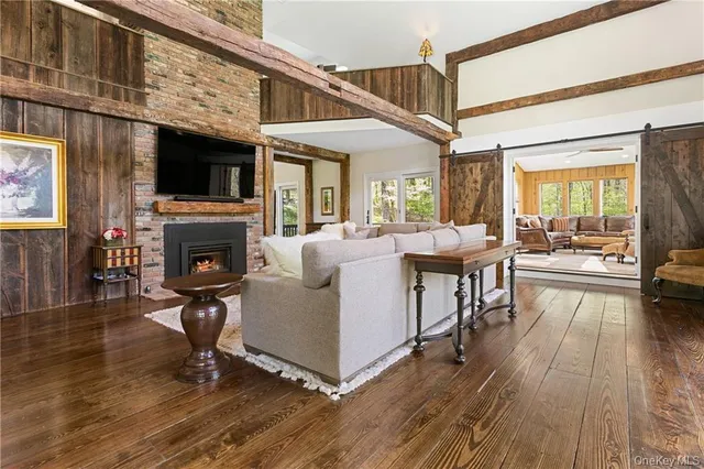 a living room with furniture a fireplace and a flat screen tv