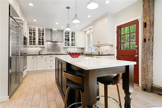 a kitchen with kitchen island a sink table and chairs
