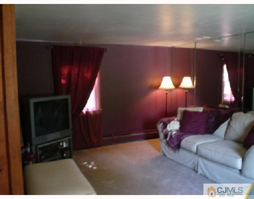 337 Manalapan Road Spotswood, NJ 08884 - Photo 4 of 10 a living room with furniture and a fireplace