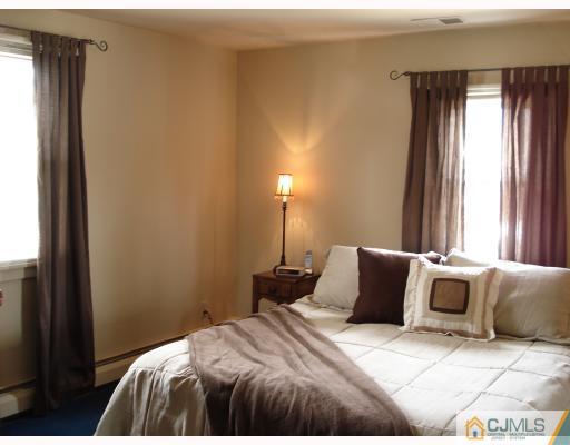337 Manalapan Road Spotswood, NJ 08884 - Photo 5 of 10 a bedroom with a bed and window