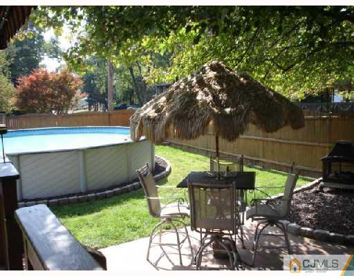337 Manalapan Road Spotswood, NJ 08884 - Photo 8 of 10 a view of a chair and table in backyard