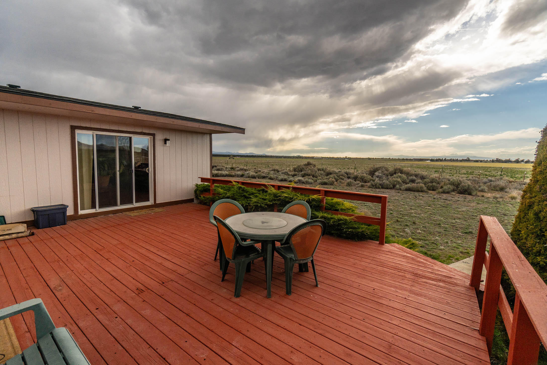 25907 South Cooper Street Bend, OR 97701 - Photo 21 of 34 a balcony with wooden floor table and chairs