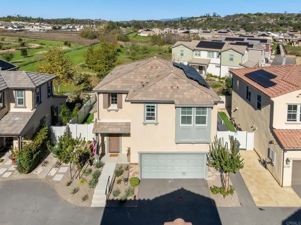 an aerial view of a house with a yard pool and outdoor seating