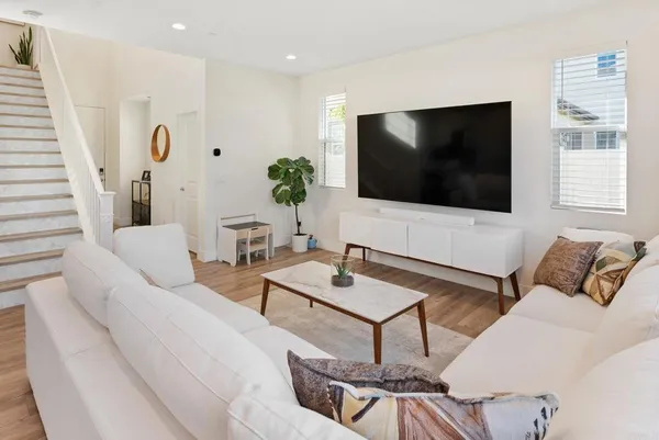 a kitchen with stainless steel appliances a dining table chairs microwave and sink