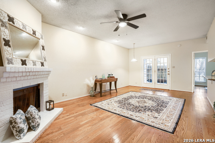 a bedroom with a bed a fireplace and a large window