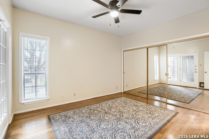 8655 Datapoint, Unit 403 San Antonio, TX 78229 - Photo 11 of 22 a view of an empty room with window and a ceiling fan