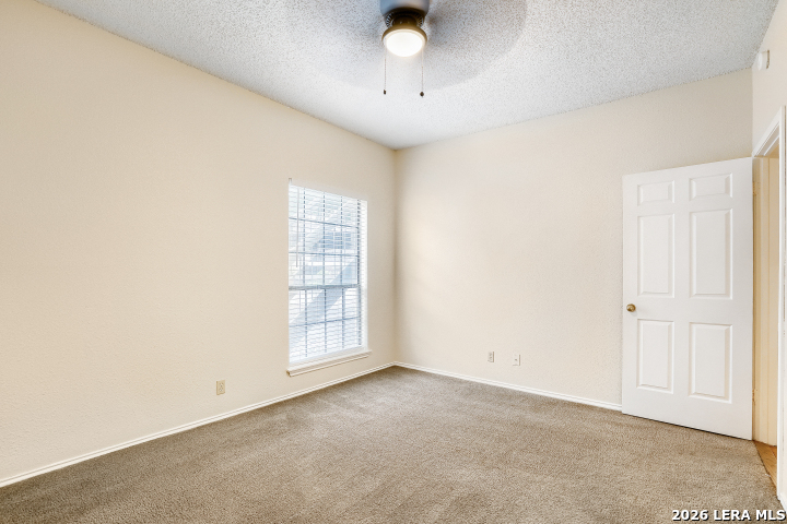 8655 Datapoint, Unit 403 San Antonio, TX 78229 - Photo 14 of 22 an empty room with chandelier fan