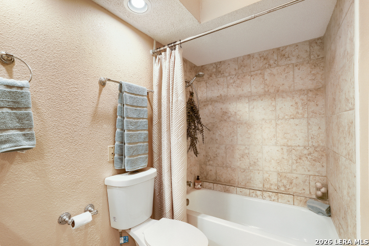 8655 Datapoint, Unit 403 San Antonio, TX 78229 - Photo 18 of 22 a bathroom with a toilet and a shower