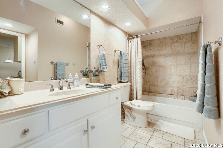 8655 Datapoint, Unit 403 San Antonio, TX 78229 - Photo 19 of 22 a bathroom with a double vanity sink toilet and shower