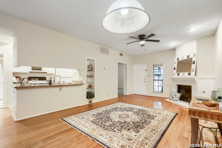8655 Datapoint, Unit 403 San Antonio, TX 78229 - Photo 6 of 22 a living room with stainless steel appliances kitchen island granite countertop furniture and a fireplace