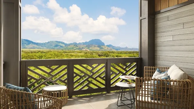a view of a chairs and table in a balcony