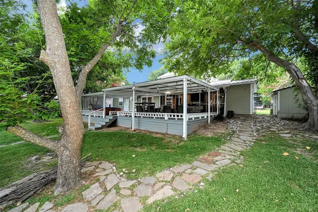 a view of a house with a backyard patio and swimming pool