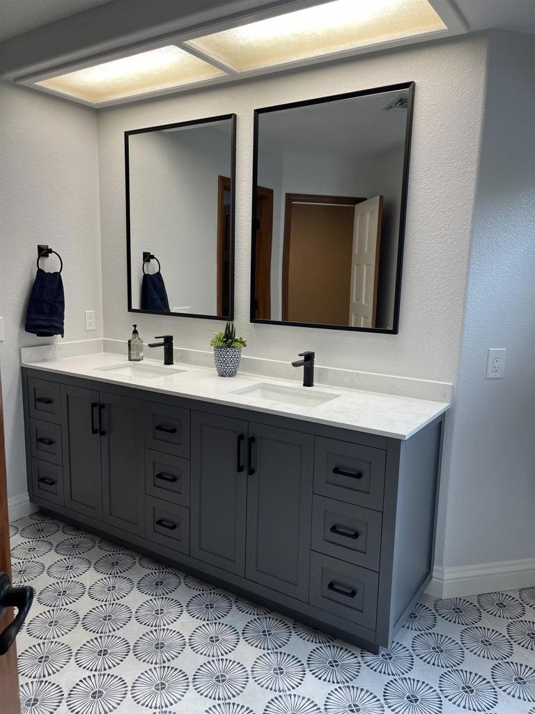 13348 Old Winery Road Poway, CA 92064 - Photo 45 of 68 a bathroom with a double vanity sink and a mirror