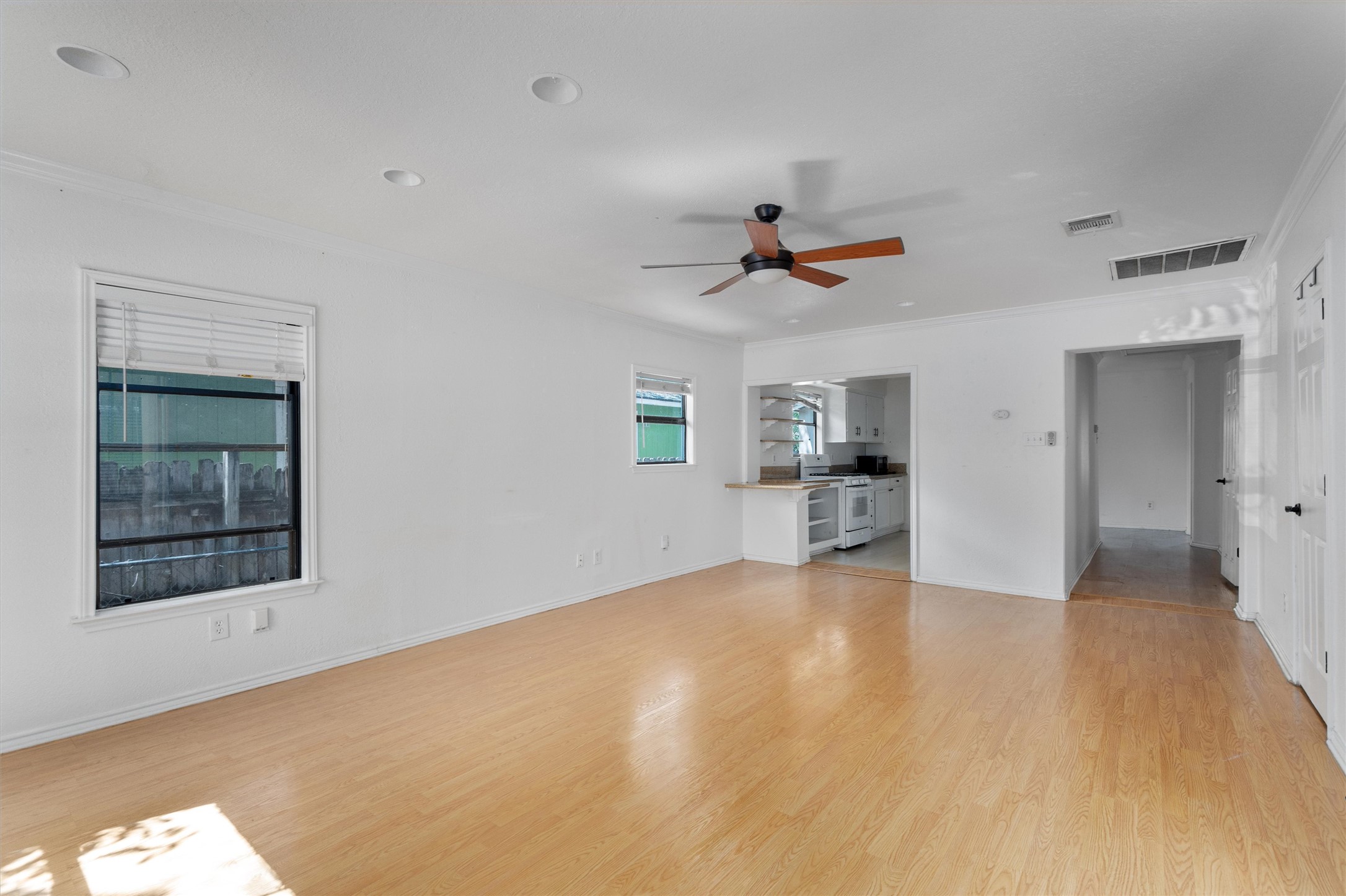 2710 East 3rd Street Austin, TX 78702 - Photo 13 of 28 a view of an empty room with a window and kitchen view
