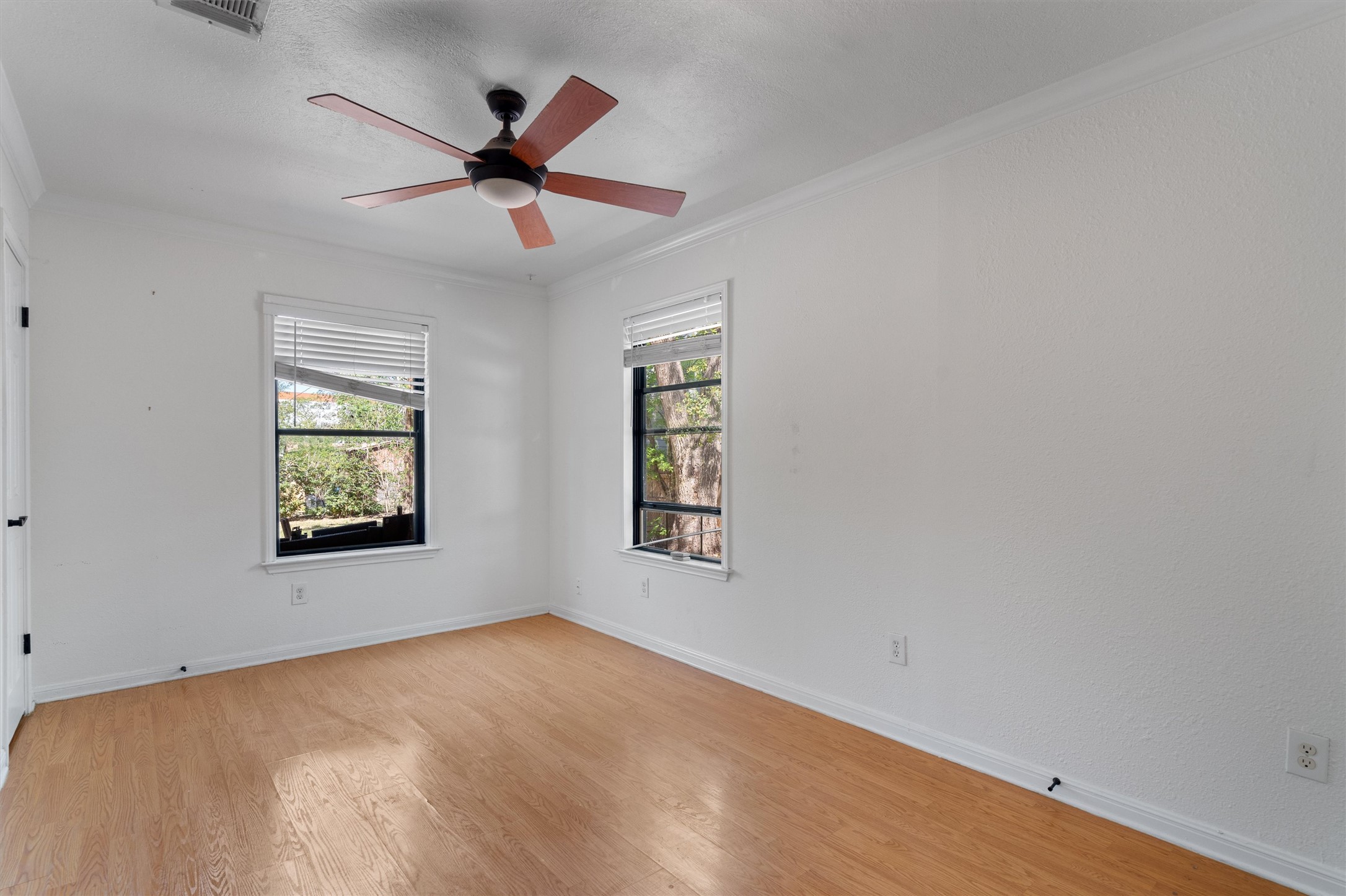 2710 East 3rd Street Austin, TX 78702 - Photo 16 of 28 an empty room with windows and ceiling fan