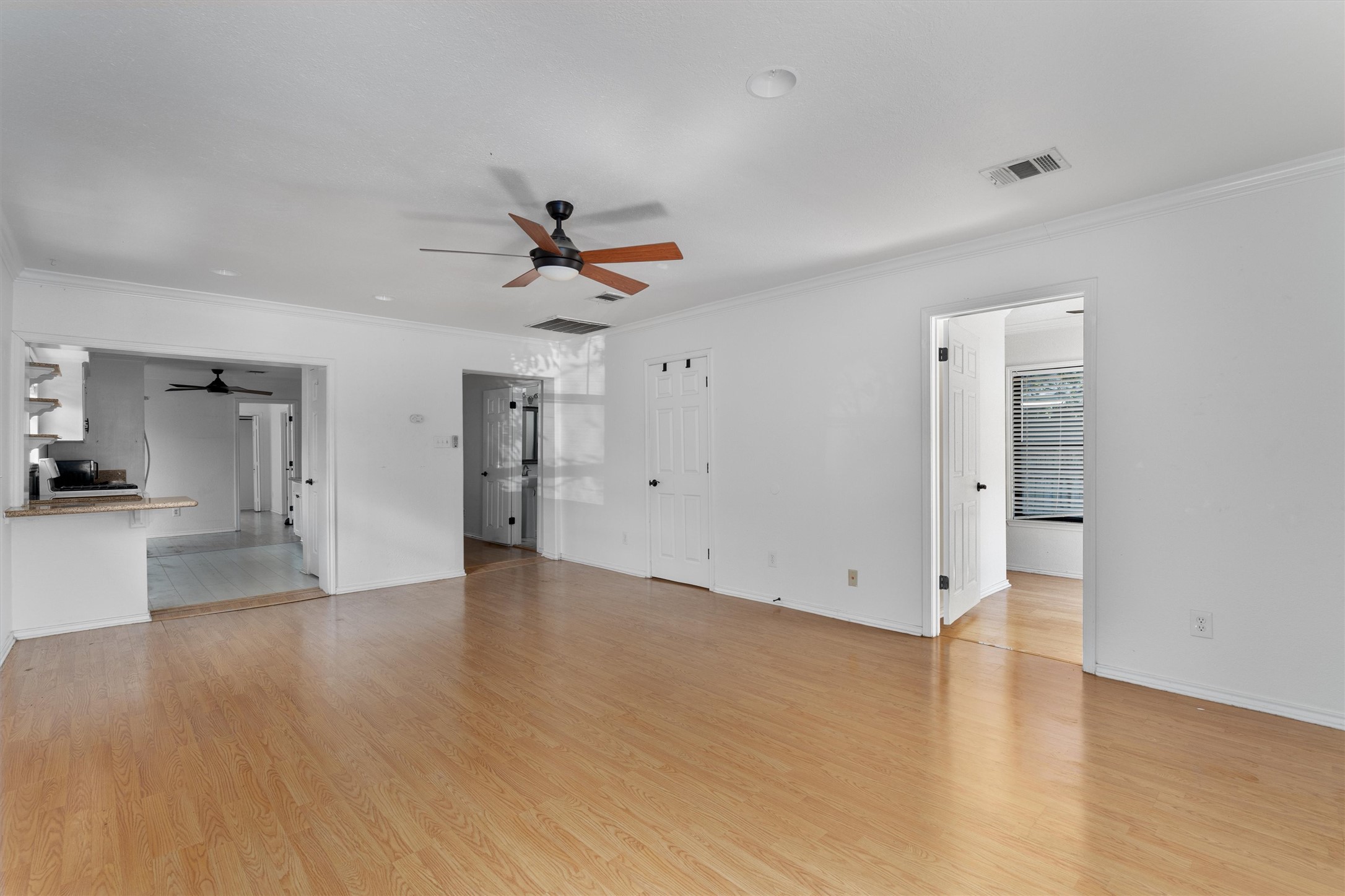 2710 East 3rd Street Austin, TX 78702 - Photo 5 of 28 wooden floor in an empty room with a window