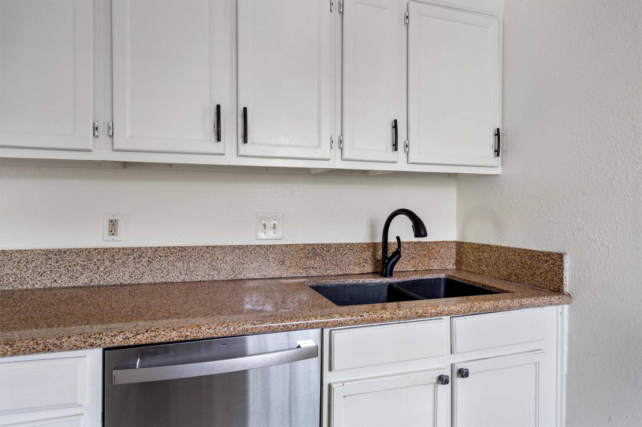 2710 East 3rd Street Austin, TX 78702 - Photo 7 of 28 a kitchen with granite countertop white cabinets and a sink
