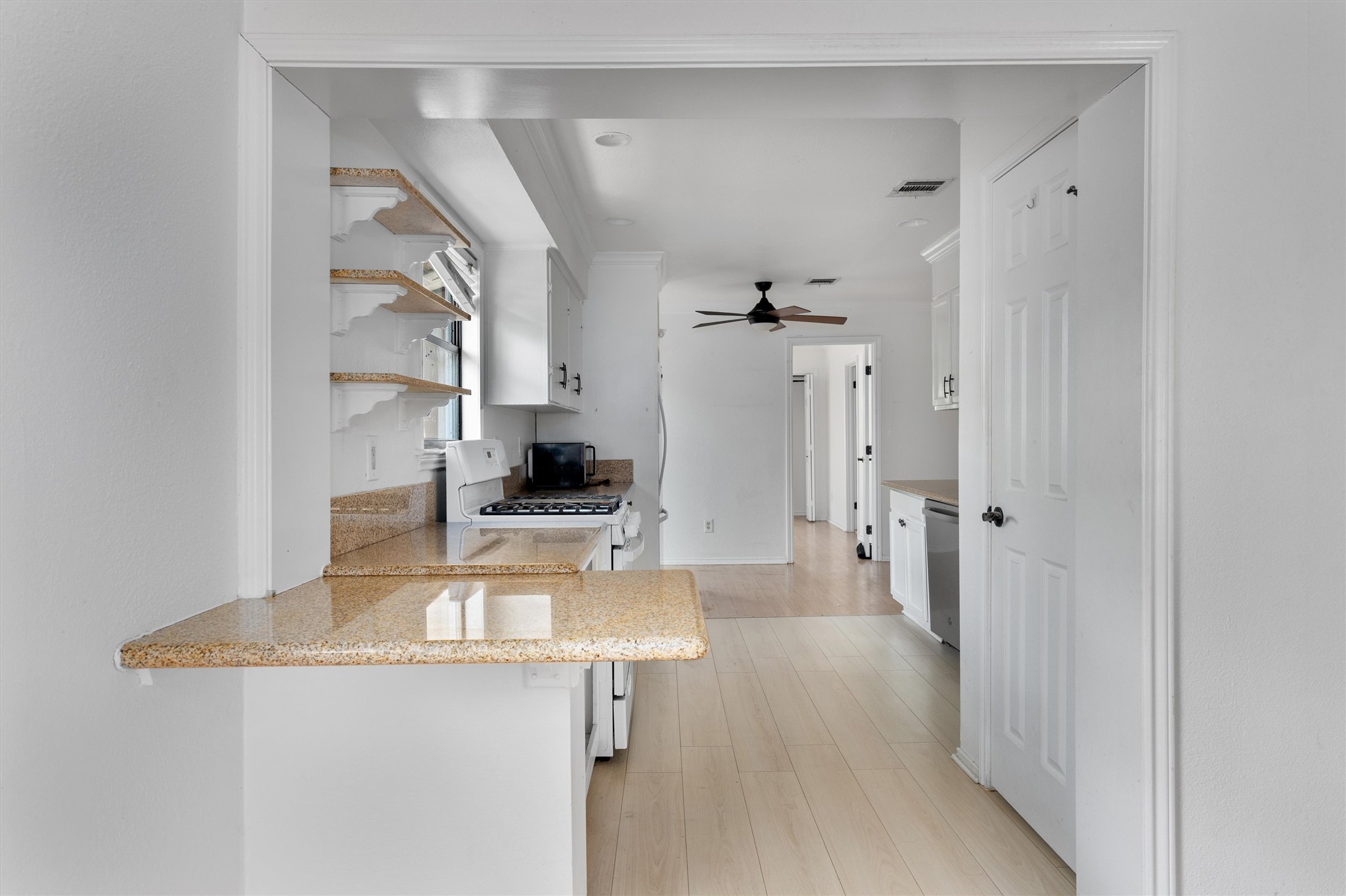 2710 East 3rd Street Austin, TX 78702 - Photo 8 of 28 a kitchen with stainless steel appliances a sink stove and refrigerator