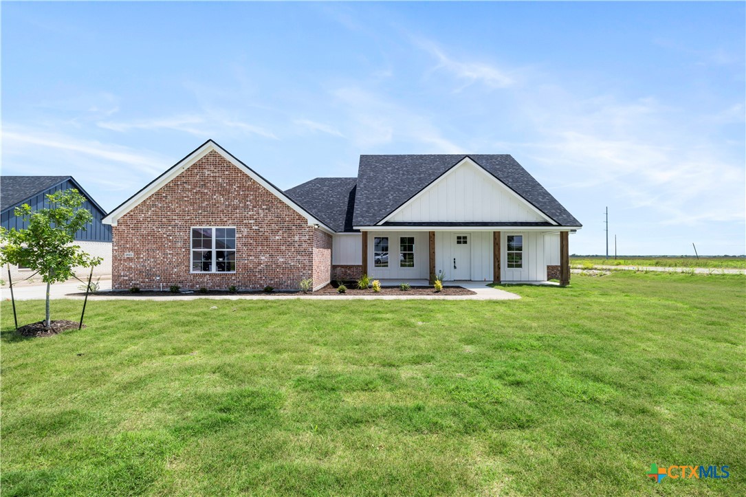 a front view of house with yard and green space