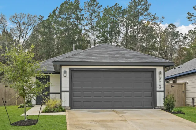 a small house with a tree in front of it