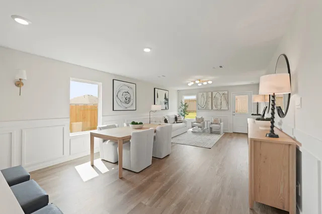 a living room with fireplace furniture and a wooden floor
