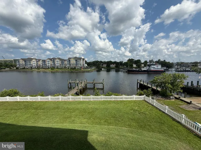 a view of a lake with houses in the back
