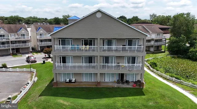 a aerial view of a house next to a yard