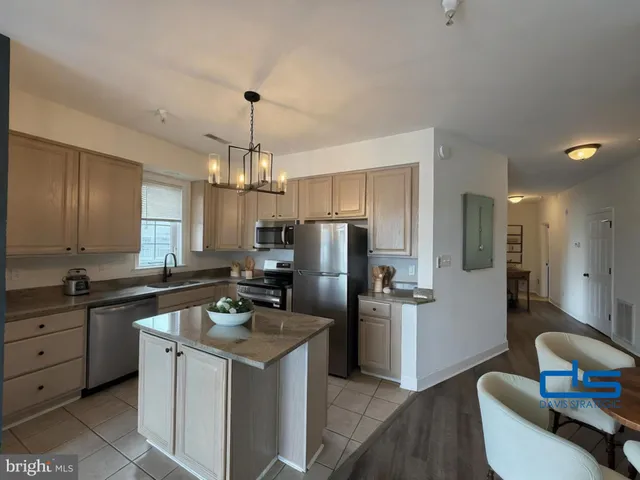 a kitchen with a refrigerator stove a sink and dishwasher