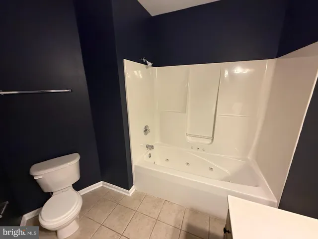a bathroom with a toilet and a bathtub