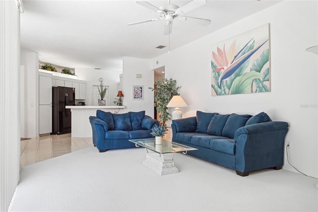 9016 Easthaven Court New Port Richey, FL 34655 - Photo 12 of 38 a living room with furniture and a chandelier