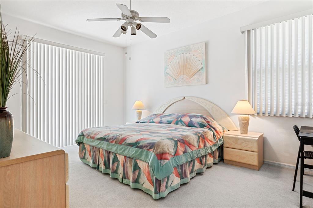 9016 Easthaven Court New Port Richey, FL 34655 - Photo 19 of 38 a bedroom with a bed table and a lamp