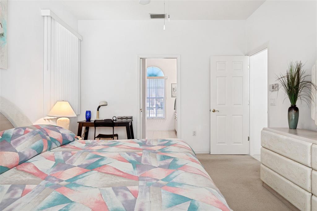 9016 Easthaven Court New Port Richey, FL 34655 - Photo 20 of 38 a bedroom with a bed and a potted plant on dresser