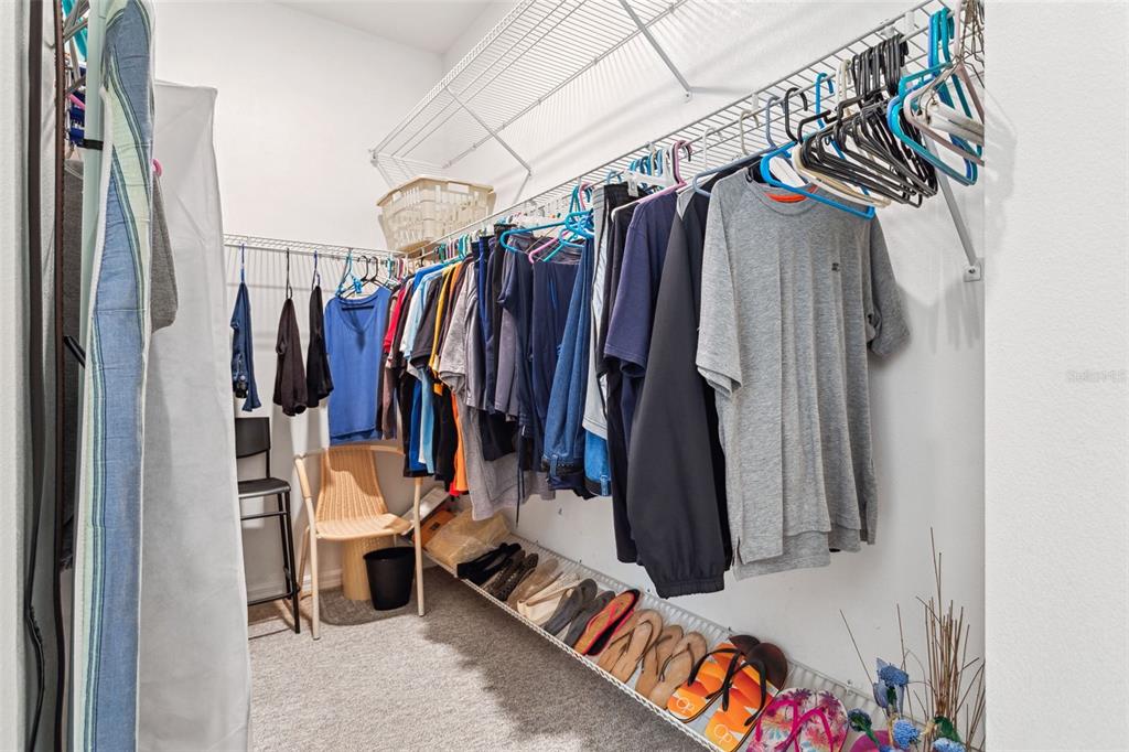 9016 Easthaven Court New Port Richey, FL 34655 - Photo 23 of 38 a view of walk in closet with clothes and shoes
