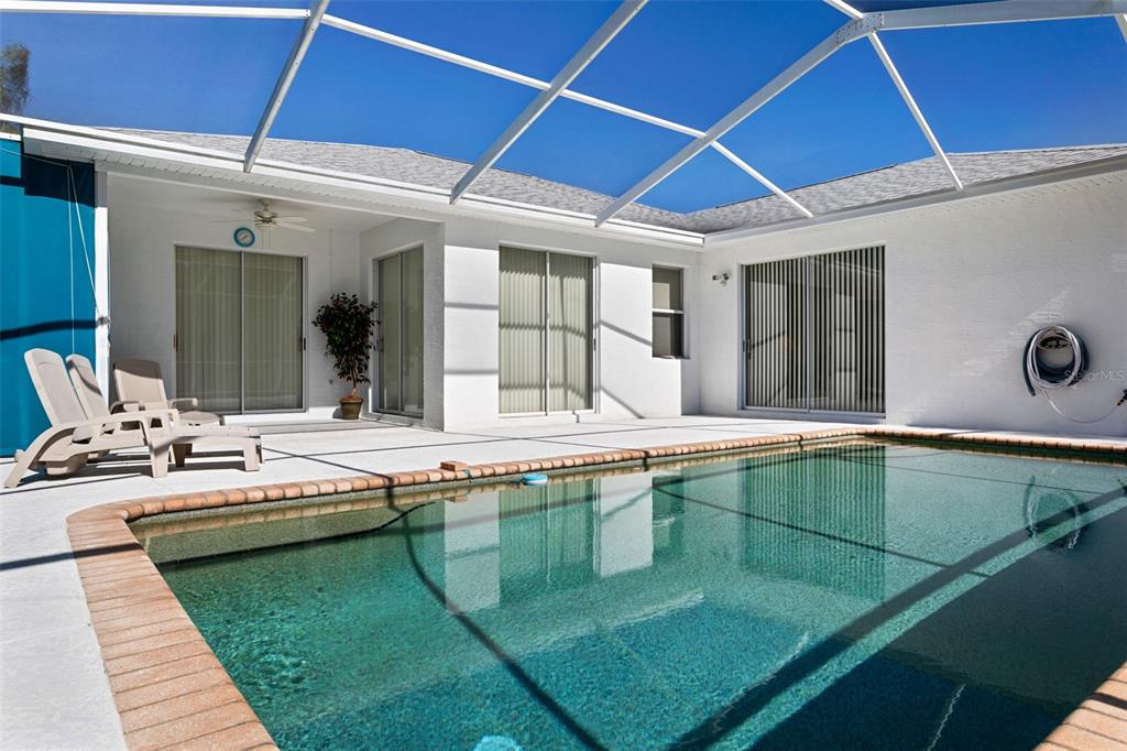9016 Easthaven Court New Port Richey, FL 34655 - Photo 28 of 38 a view of a backyard with swimming pool and chairs