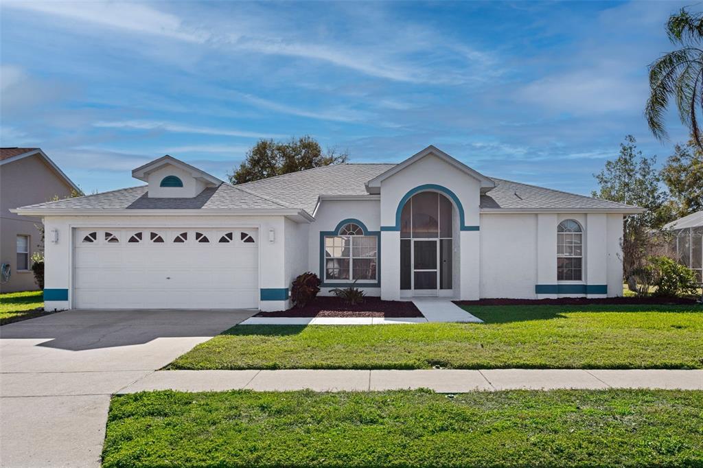 9016 Easthaven Court New Port Richey, FL 34655 - Photo 3 of 38 a front view of a house with a garden and yard