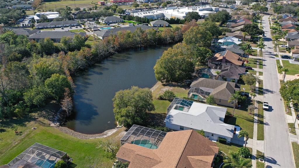 9016 Easthaven Court New Port Richey, FL 34655 - Photo 33 of 38 an aerial view of a house with a yard and lake view