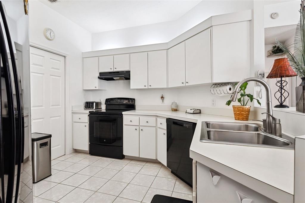 9016 Easthaven Court New Port Richey, FL 34655 - Photo 9 of 38 a kitchen with a sink cabinets and stainless steel appliances