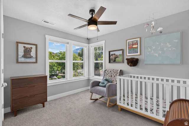 1263 East 1200th South Springville, UT 84663 - Photo 27 of 60 Bright room featuring multiple windows, a ceiling fan with integrated lighting, and carpet flooring