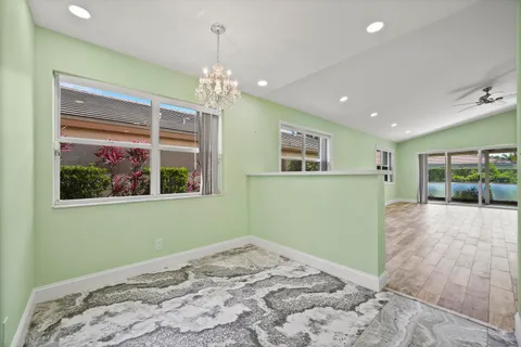 a view of a kitchen with a refrigerator and a sink