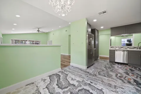 a kitchen with a sink stainless steel appliances and cabinets