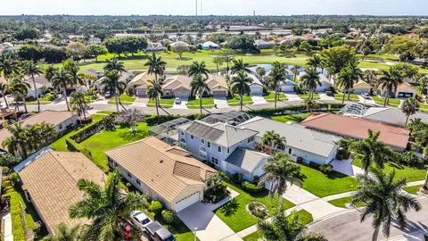 an aerial view of residential houses with outdoor space and swimming pool