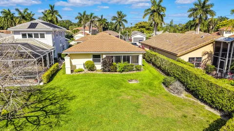 a front view of a house with a yard and potted plants