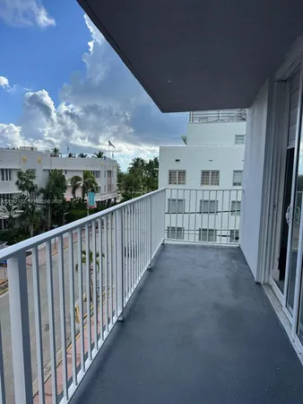 a kitchen with stainless steel appliances granite countertop a sink a stove a microwave and a refrigerator