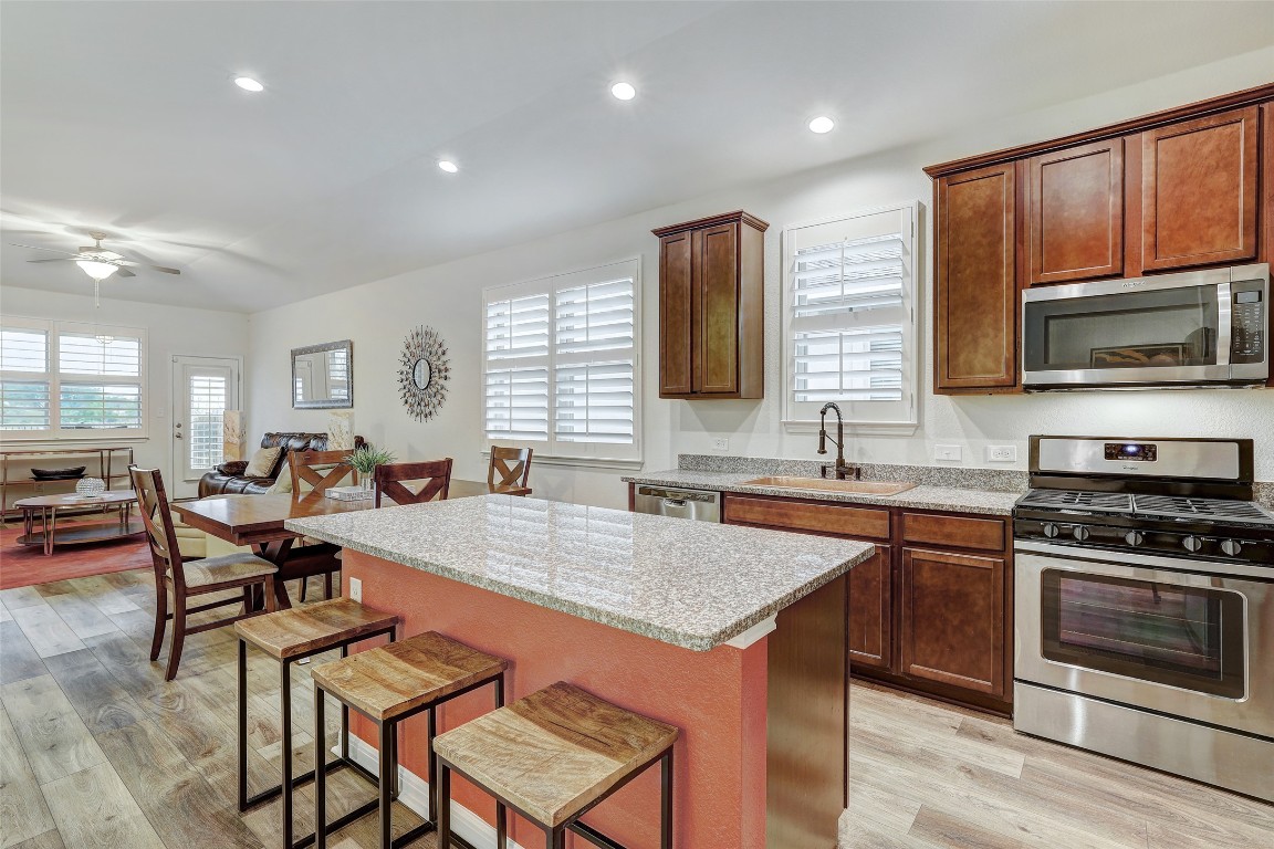 281 Diamond Point Drive Dripping Springs, TX 78620 - Photo 1 of 1 a open kitchen with stainless steel appliances granite countertop a stove top oven a sink dishwasher a dining table and chairs with wooden floor