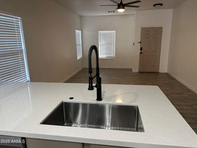 a kitchen with a sink and chandelier